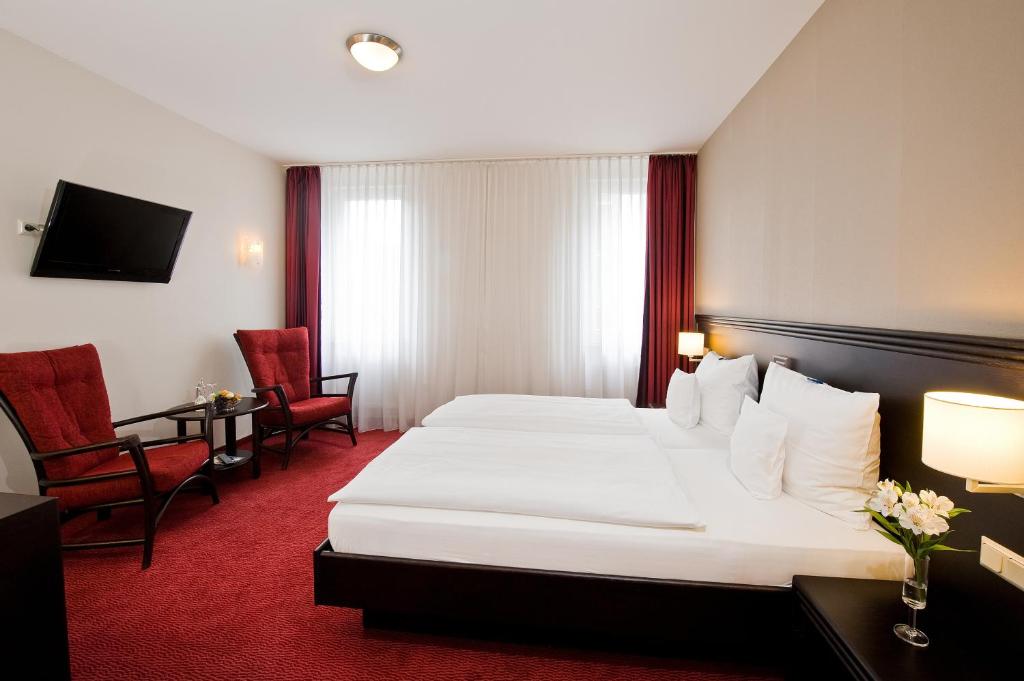 Postel nebo postele na pokoji v ubytování Göbel's Sophien Hotel