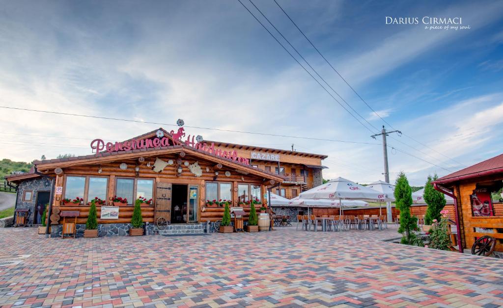 a building with a restaurant on a brick street at Pensiunea Haiducilor in Bistriţa