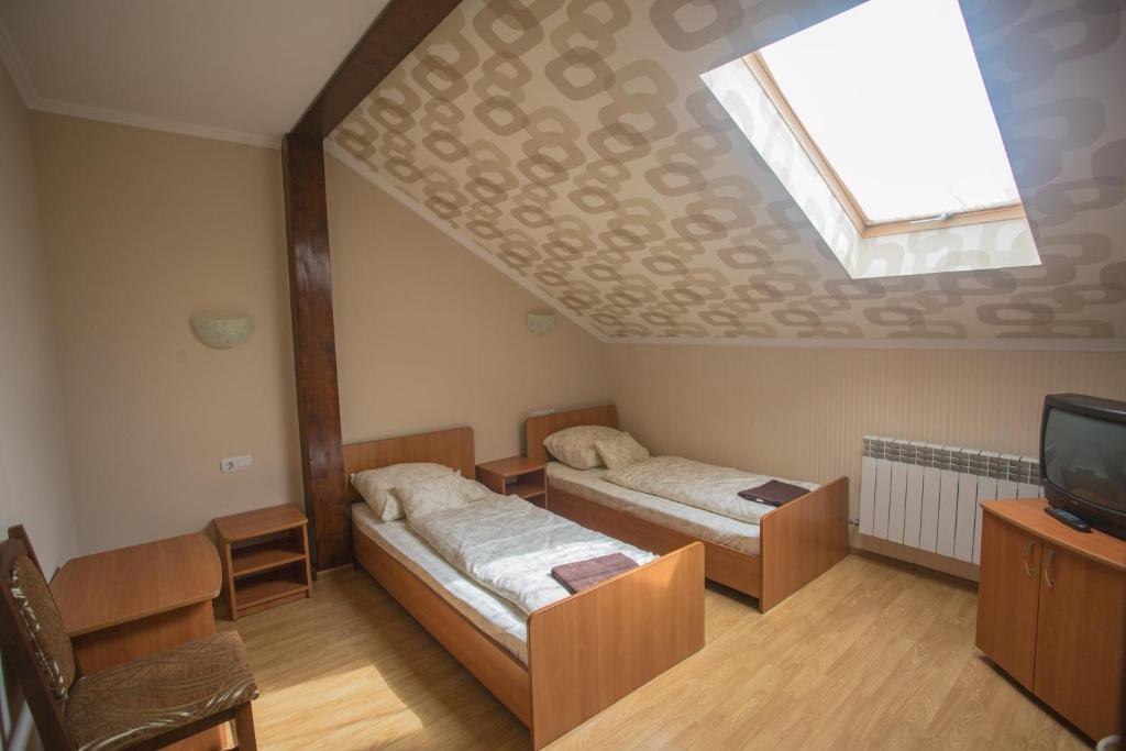 Postel nebo postele na pokoji v ubytování Praktik Hotel & Restaurant
