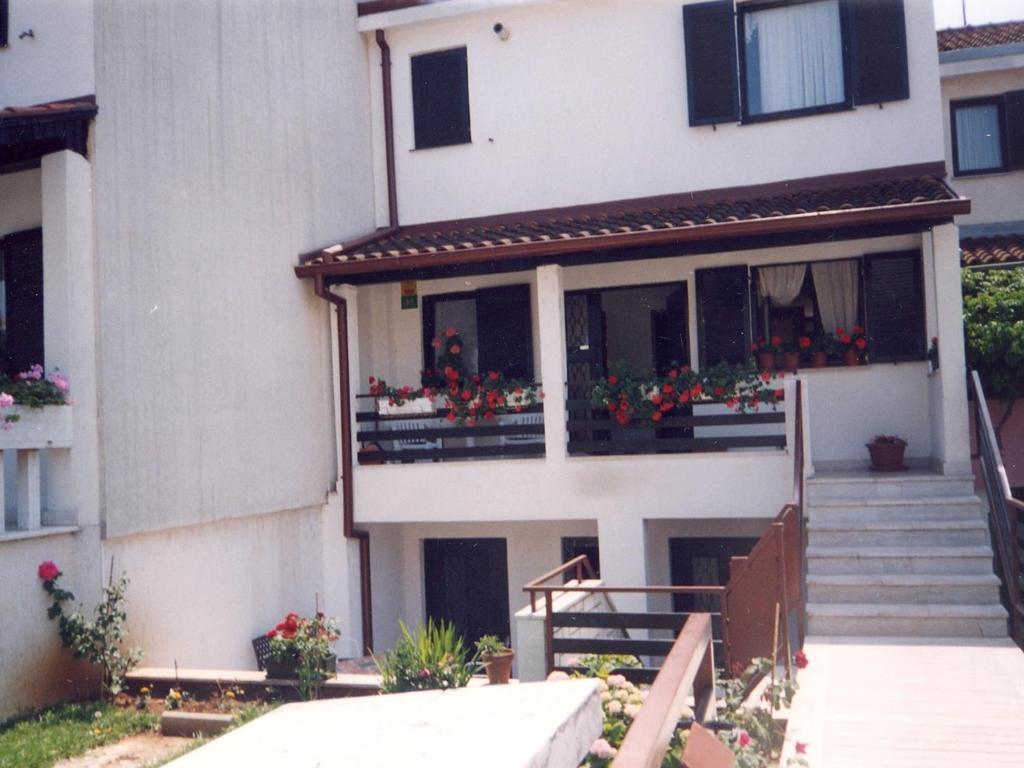 a building with flower boxes on the balconies at Studio Apartment Pula near Sea 2 in Pješčana Uvala 