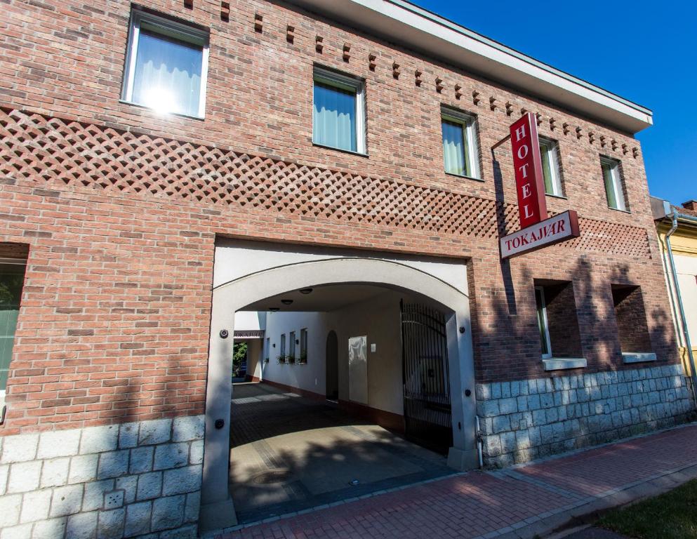 a brick building with an archway in front of it at Tokajvár Hotel in Tokaj