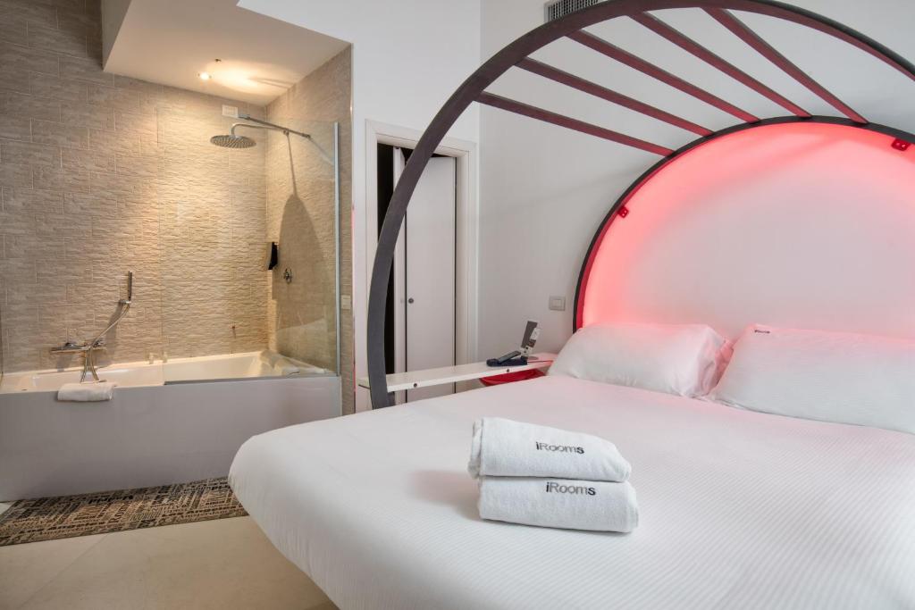 a bedroom with a large bed and a bath tub at Wrooms Guest House in Rome