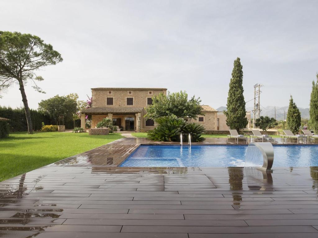 a swimming pool in front of a house at Es Pouet in Binissalem