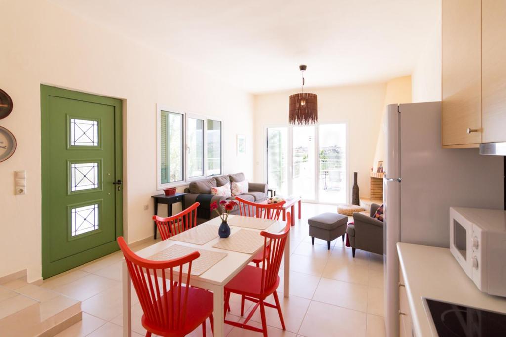 kuchnia i salon ze stołem i krzesłami w obiekcie Athena Villas Olive Grove & Estate w mieście Guwes
