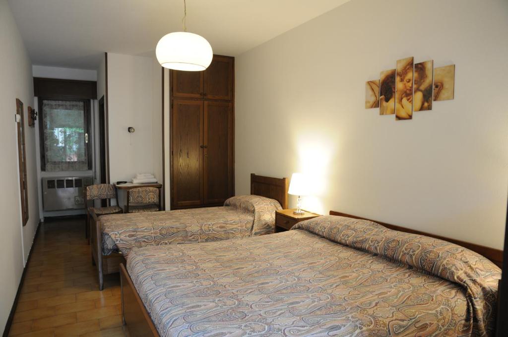 Postel nebo postele na pokoji v ubytování Hotel Eternità