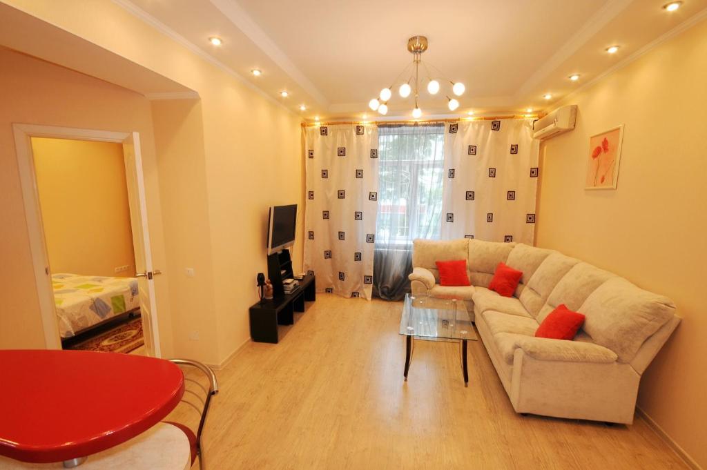 a living room with a couch and a table at Wonderful apartment on street Stefan cel mare 132 in Chişinău