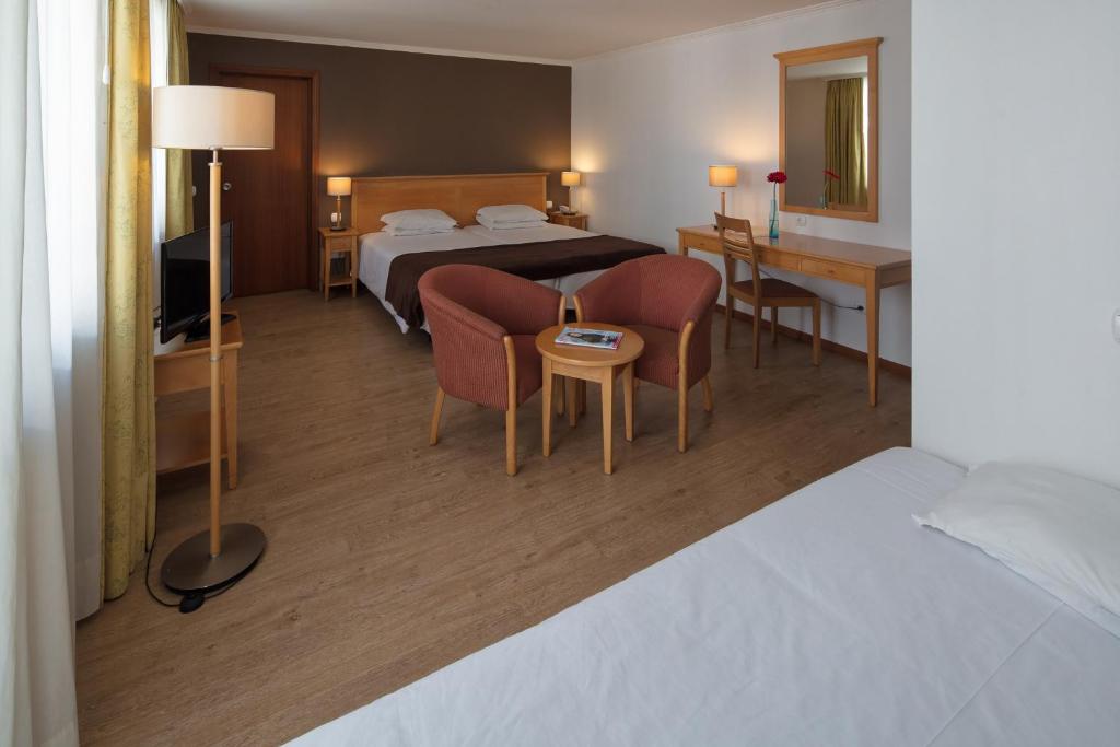 Postel nebo postele na pokoji v ubytování Hotel Orquidea