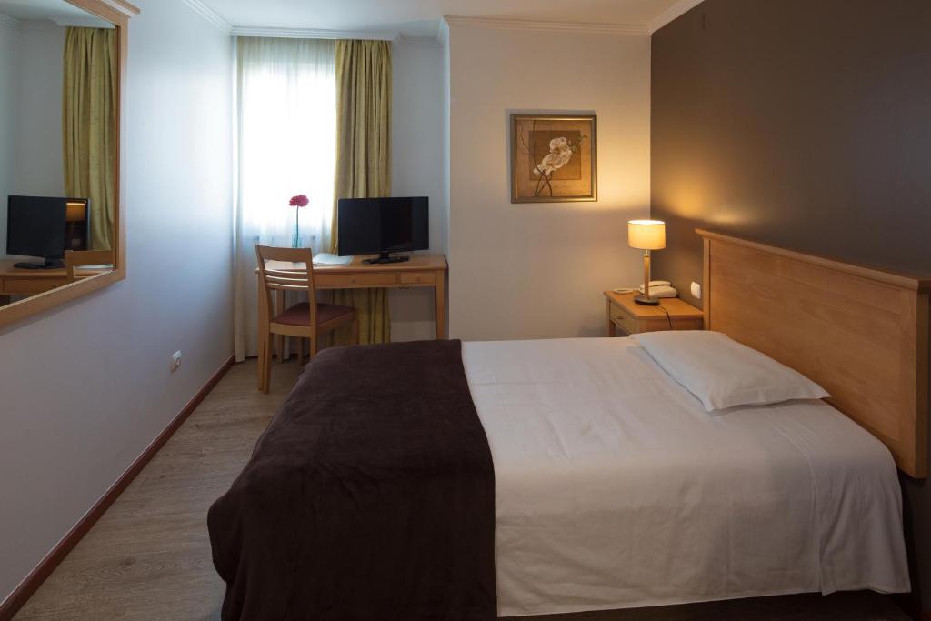 Postel nebo postele na pokoji v ubytování Hotel Orquidea