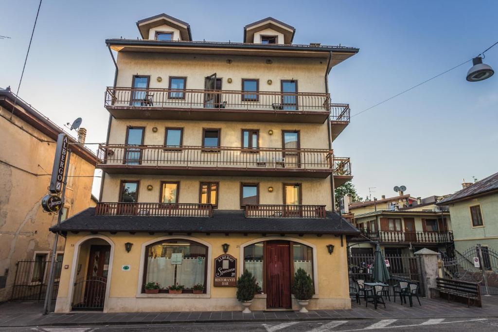 a tall building with balconies on top of it at Albergo Speranza in Asiago
