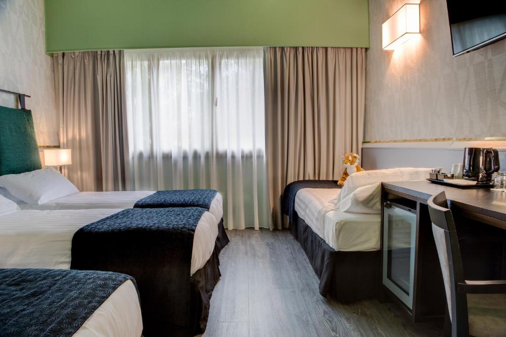 Postel nebo postele na pokoji v ubytování Best Western Plus CHC Florence