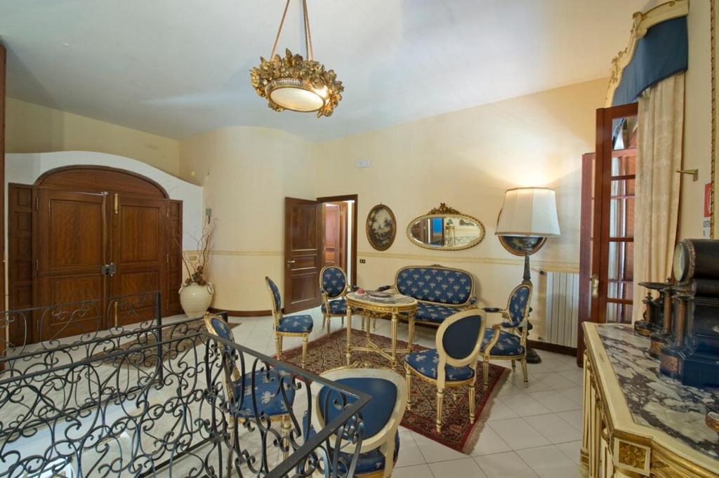 a living room with blue chairs and a table at Casa Felice in Ravello