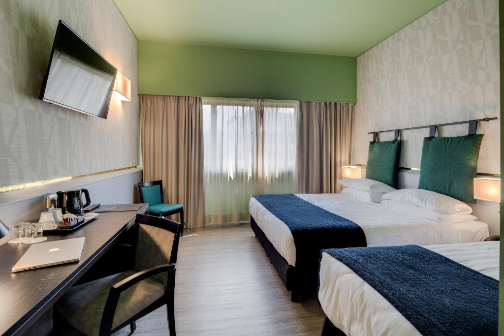 Postel nebo postele na pokoji v ubytování Best Western Plus CHC Florence