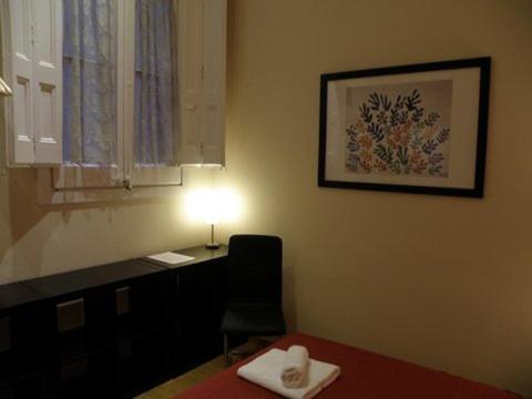 a room with a desk with a chair and a light at Center Gran Via in Barcelona