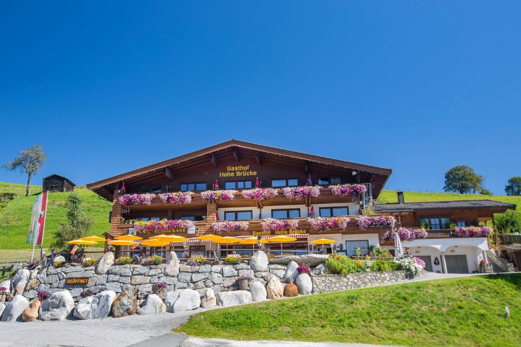 a building with umbrellas in front of it at Aparthotel Hohe Brücke-NPHT Sommercard inklusive in Mittersill