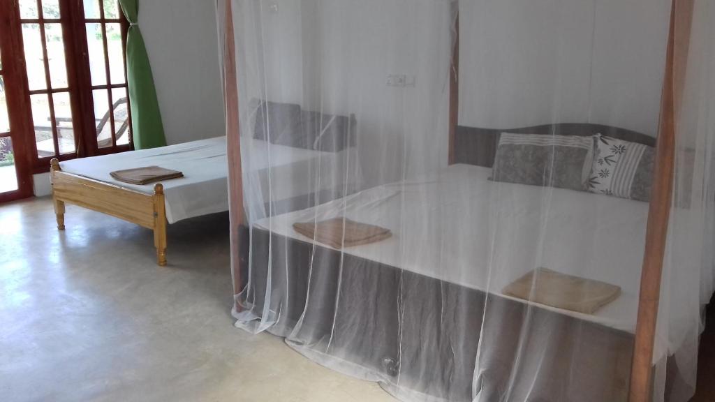 Postel nebo postele na pokoji v ubytování Nelu Villa Sigiriya