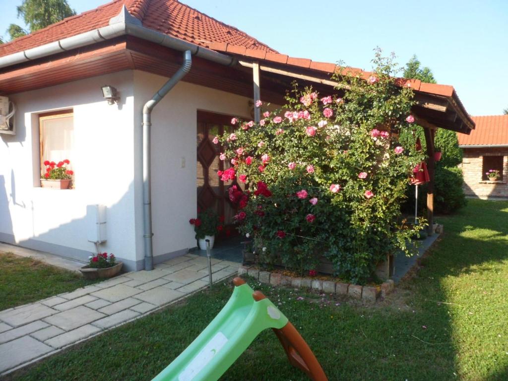 a small house with a slide in the yard at Holiday home Balatonbereny/Balaton 18044 in Balatonberény