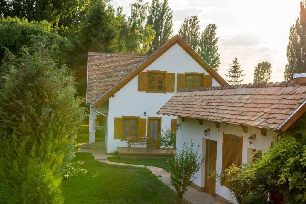 a white house with a brown roof at Hajnalka Apartment in Badacsonytomaj