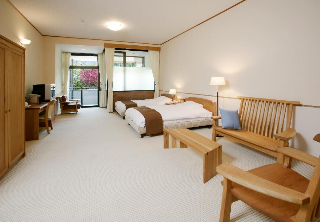Postel nebo postele na pokoji v ubytování Nakao Kogen Hotel Kazaguruma