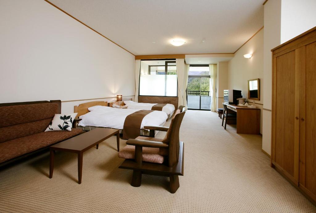 Postel nebo postele na pokoji v ubytování Nakao Kogen Hotel Kazaguruma
