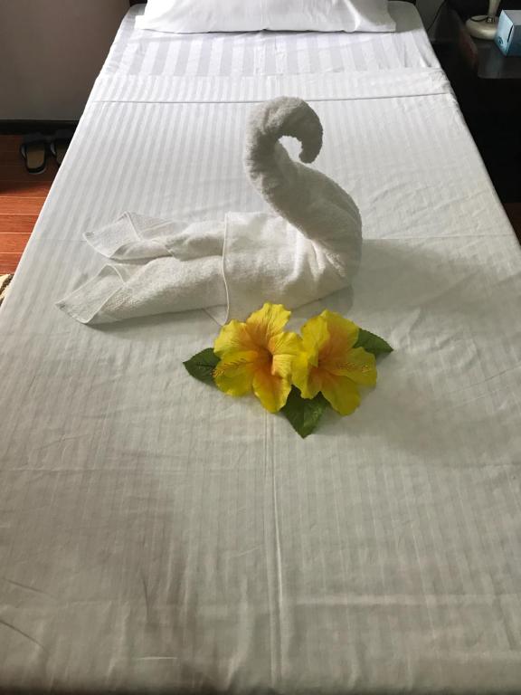 a swan made out of towels on a bed at Ranile's Pension House in Cebu City