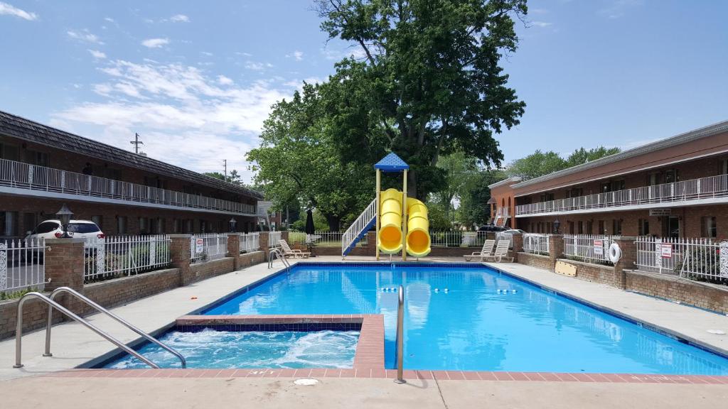 a swimming pool with a slide in a building at South Shore Inn in Sandusky