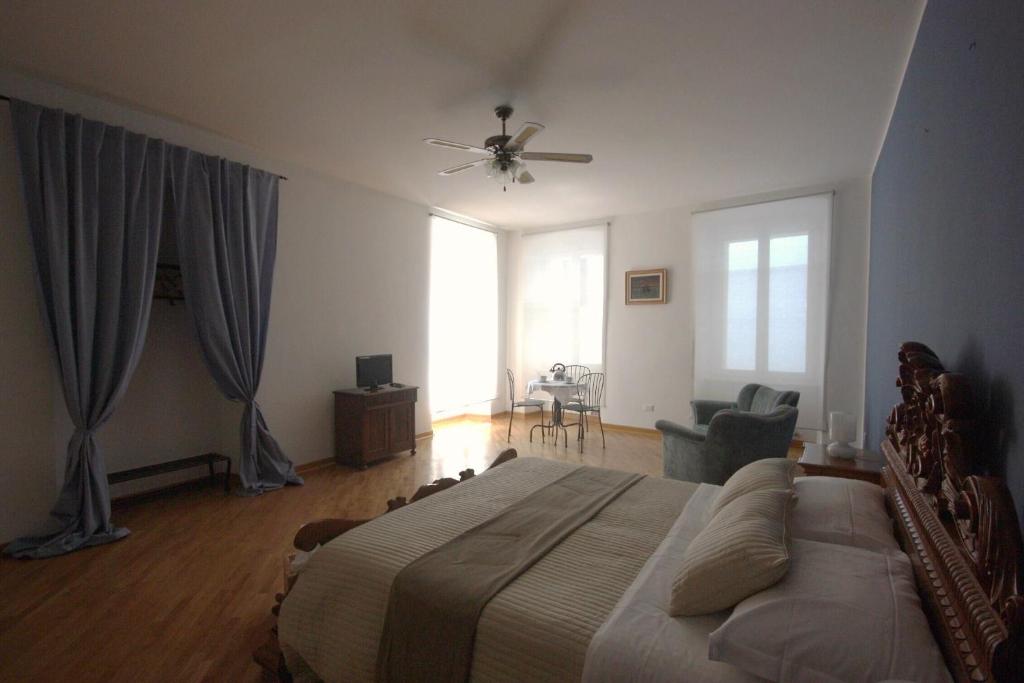 a bedroom with a bed and a ceiling fan at Palazzo Brigido in Trieste