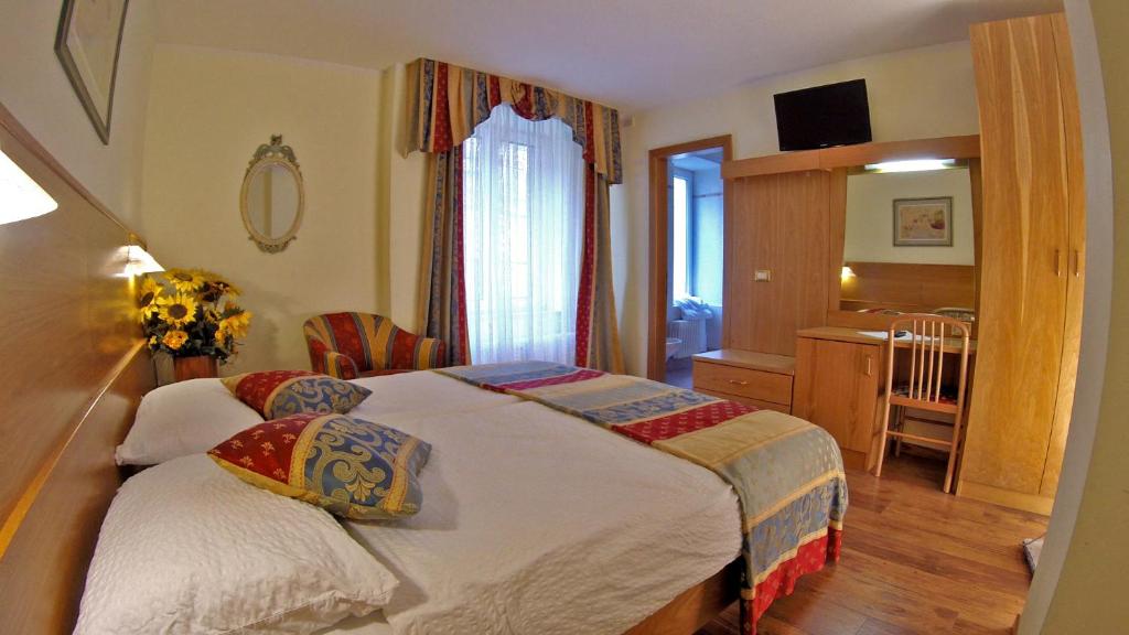 Postel nebo postele na pokoji v ubytování Hotel Olympia