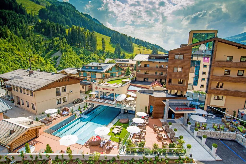 an aerial view of a resort with a swimming pool at Alpinresort ValSaa - Sport & Spa in Saalbach-Hinterglemm