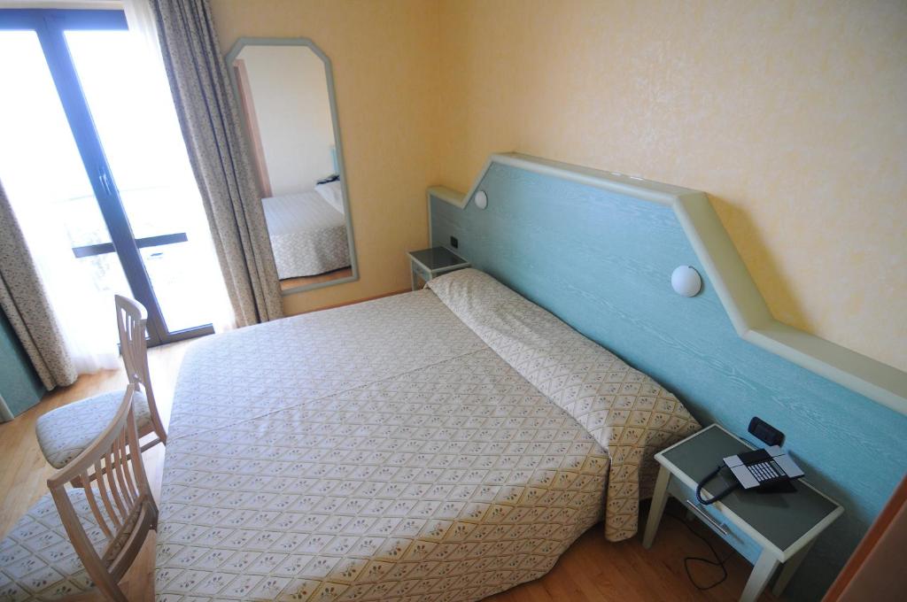 Postel nebo postele na pokoji v ubytování Hotel Residence Mondial