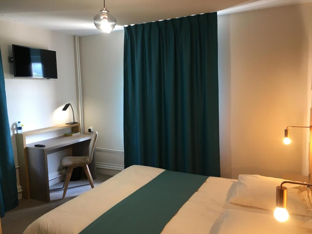 a bedroom with a bed and a desk and a green curtain at Hotel Du Pont in La GrandʼCombe-Châteleu