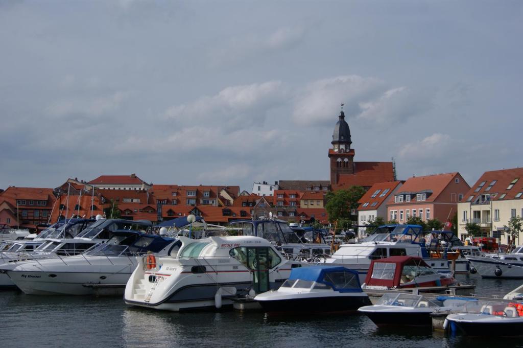 a bunch of boats are docked in a harbor at Haus Kim - Apartments in Waren