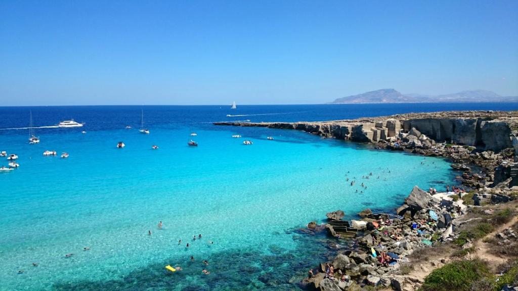 a group of people in the water at a beach at Le Casette a Favignana in Favignana