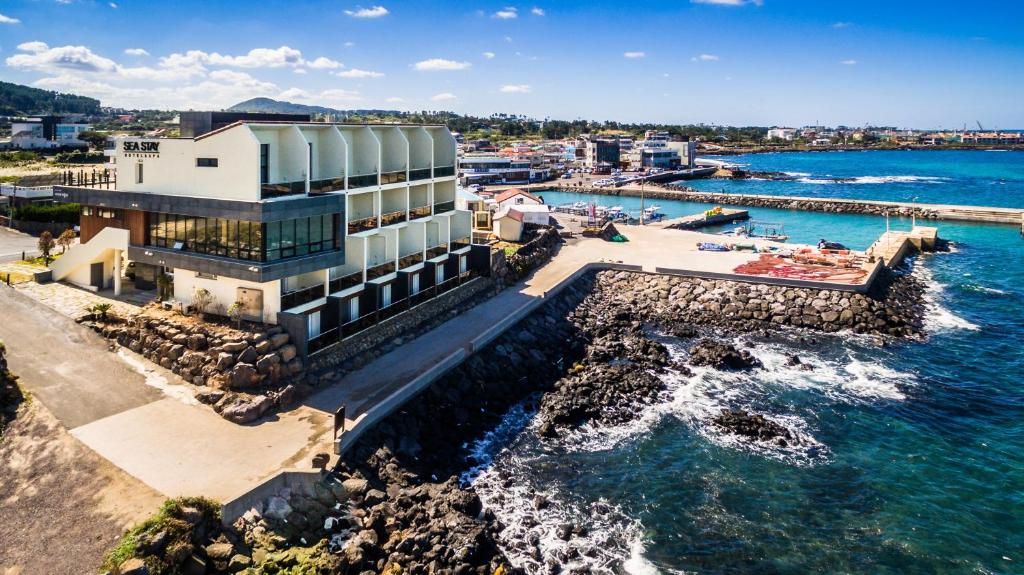 an aerial view of a building next to the water at Sea Stay Hotel in Jeju