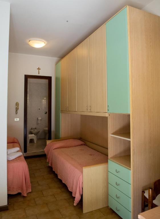 Postel nebo postele na pokoji v ubytování Hotel Malibran