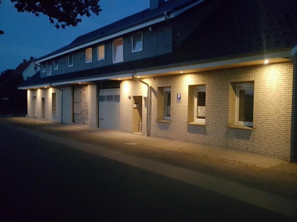 a brick building with lights on the side of it at Pension Citytravel in Espelkamp-Mittwald