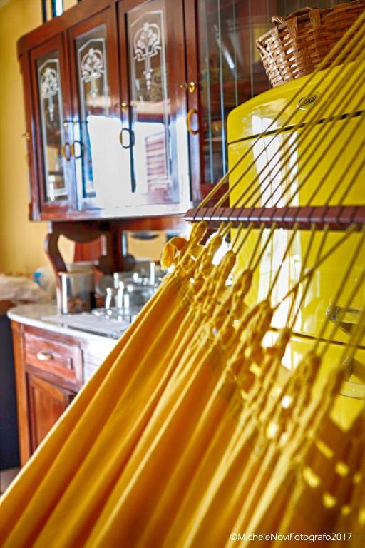 a kitchen with a yellow refrigerator and a counter at La Casa di Ivana in San Nicola Arcella
