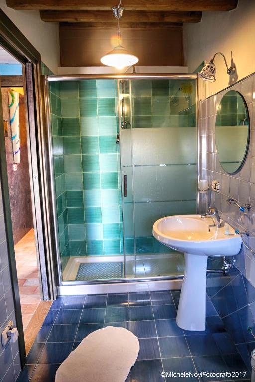 a bathroom with a sink and a shower at La Casa di Ivana in San Nicola Arcella