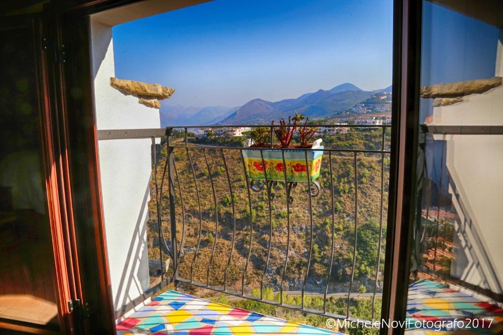 a window with a view of a city and mountains at La Casa di Ivana in San Nicola Arcella