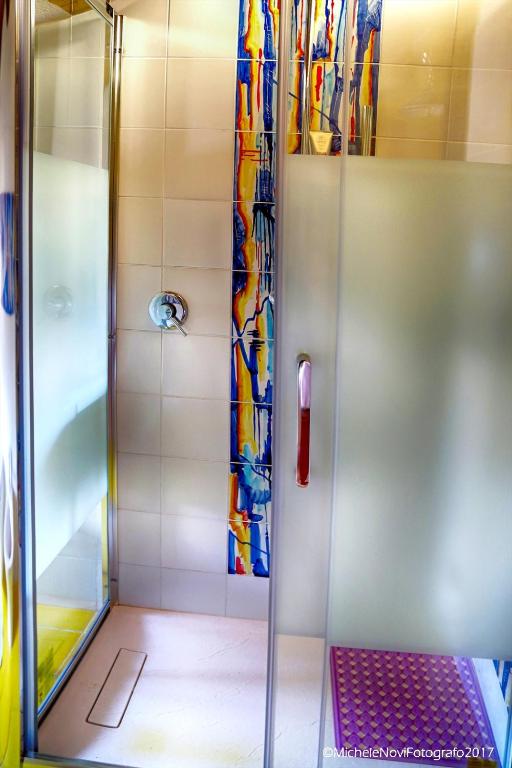 a shower with a glass door in a bathroom at La Casa di Ivana in San Nicola Arcella
