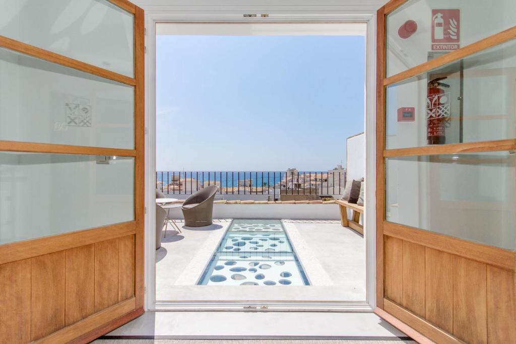 an open door to a balcony with a view at La Serena Boutique Hotel & Wellness - Altea in Altea