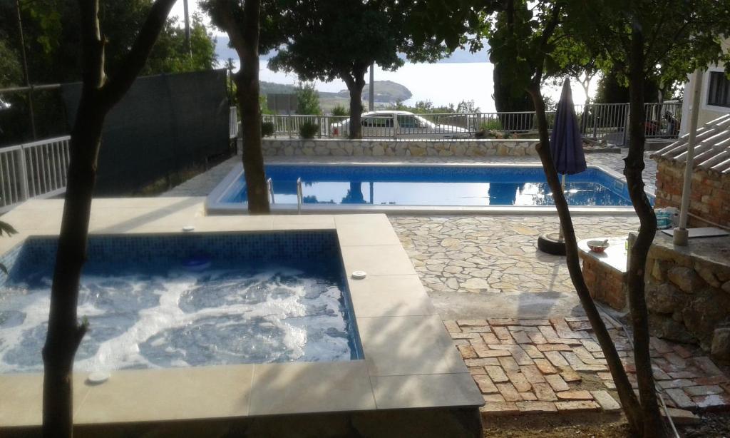 a swimming pool in a yard with a pool at Apartments Vila Zagorje in Stinica