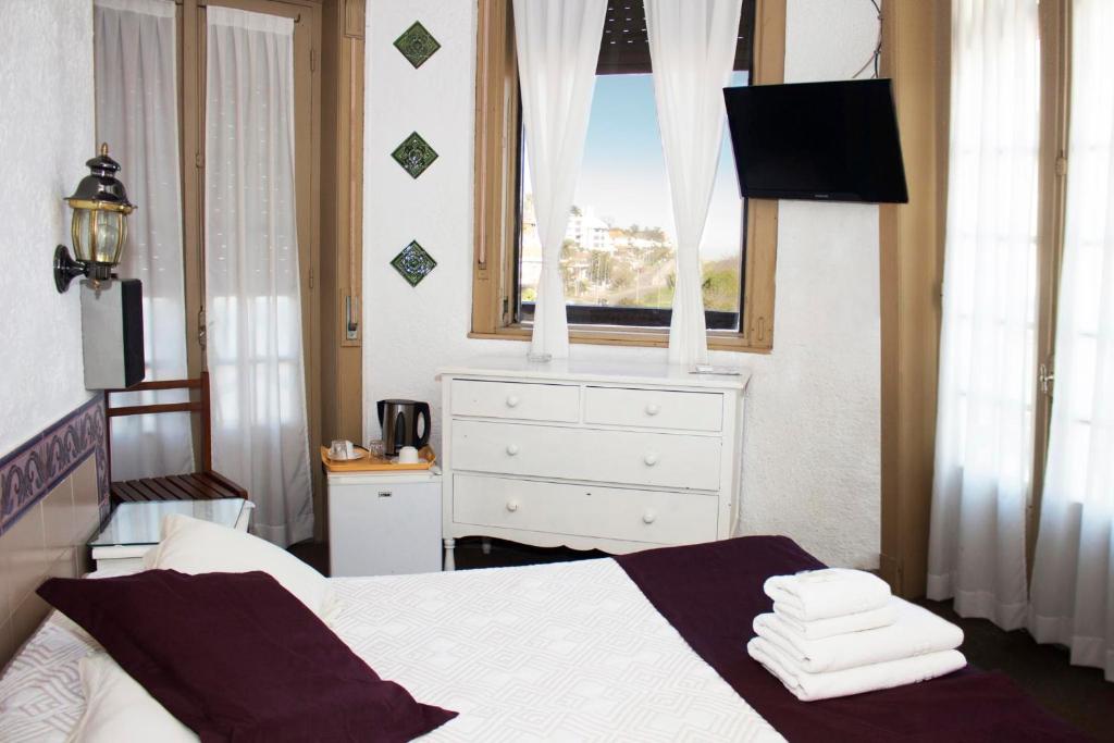 Postel nebo postele na pokoji v ubytování Hotel Colón