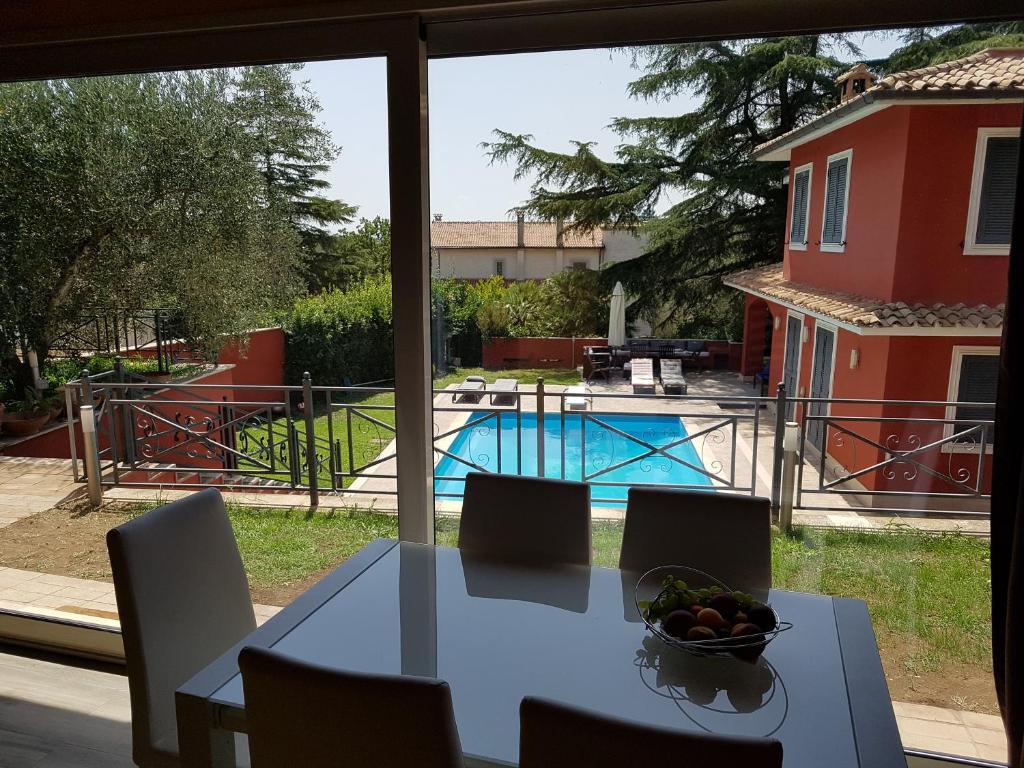 RianoにあるVILLA IL CICLAMINO - PISCINA PRIVATA IN MURATURA AD USO ESCLUSIVO - PRIVATE IN-GROUND POOL FOR EXCLUSIVE USE - 70m2 house & 300m2 outdoor, 10 minutes drive to Montebello Station linked to Rome centre in 20 minutes, 3 minutes to the villageのテーブル(椅子付)とフルーツの盛り合わせ