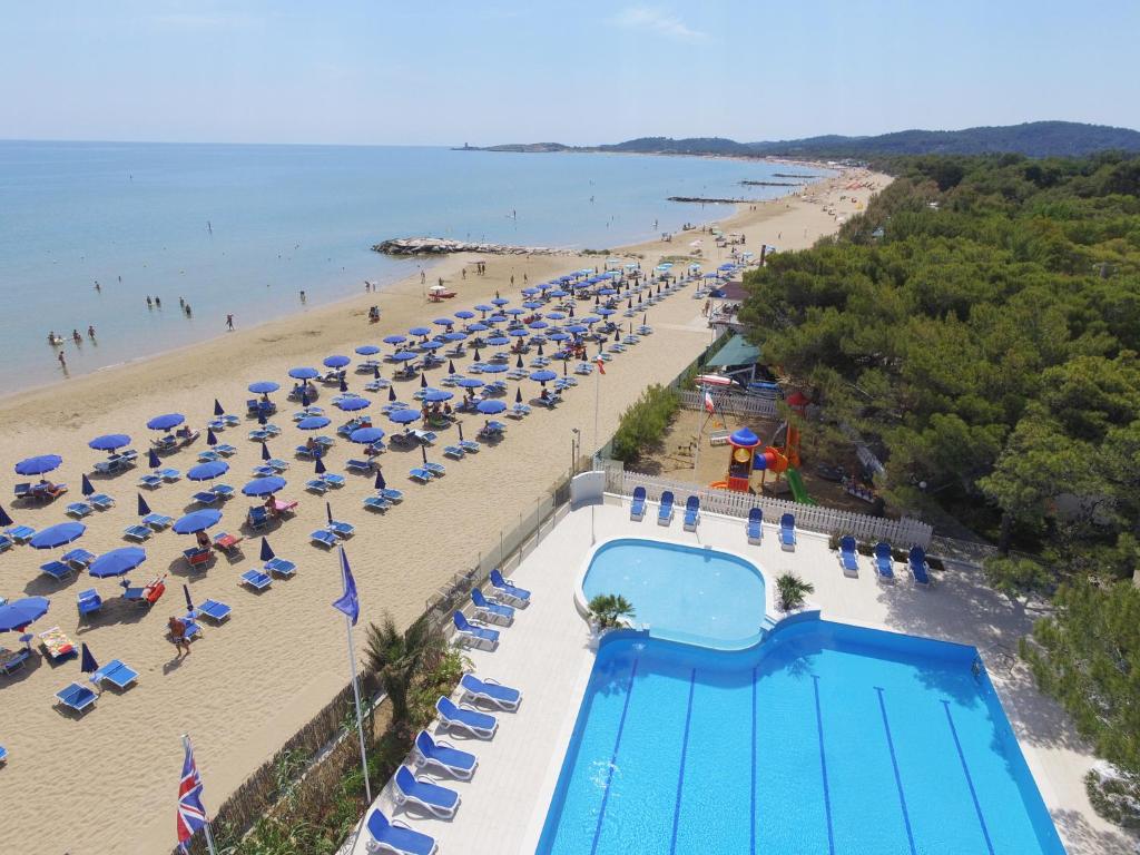 an aerial view of a beach with umbrellas and a swimming pool at Hotel Gabbiano Beach in Vieste