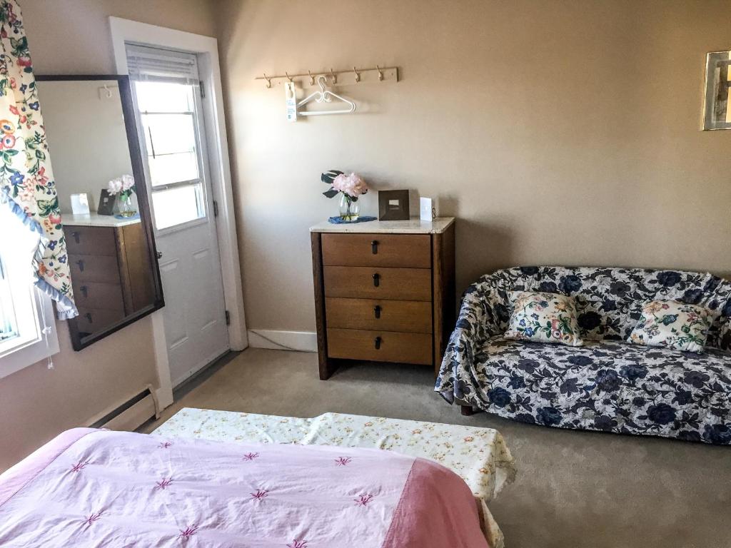 a living room with a bed and a couch at Admiral's Quay Motel & Suites in Saint John