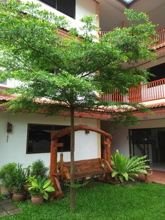 a tree in the yard of a house at Villa Oranje Chiang Mai in Chiang Mai