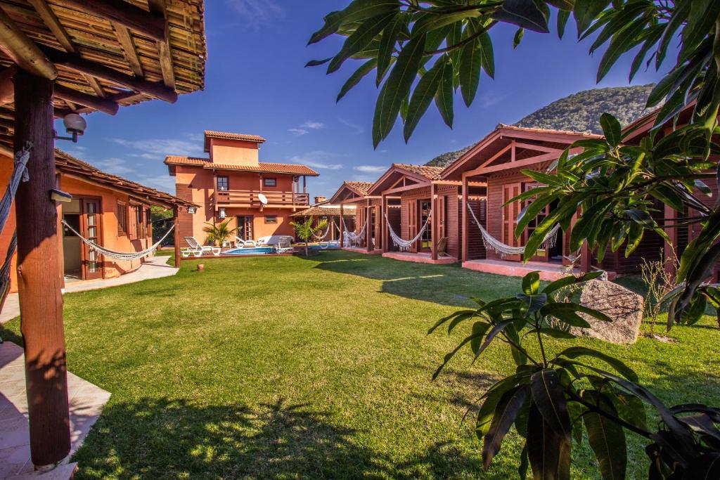 an exterior view of a house with a yard at Green Mountain Pousada in Florianópolis