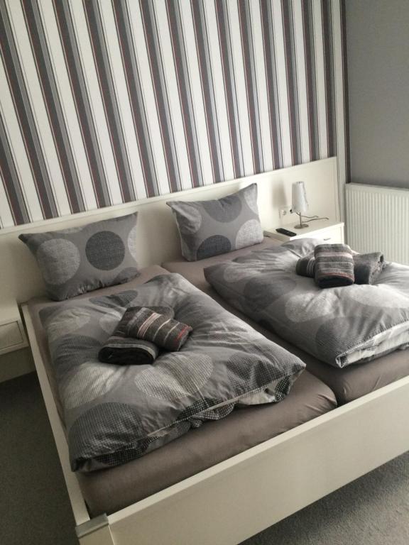 two beds with pillows on them in a bedroom at Gästehaus Djuren in Roggenstede