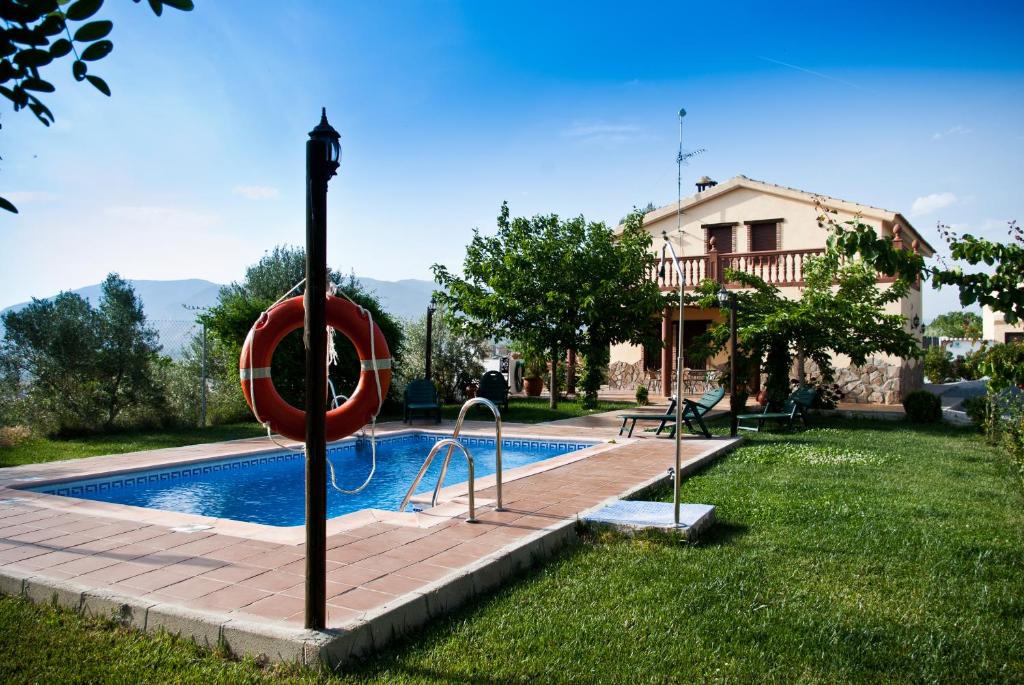 a swimming pool with a red ring in a yard at Casas Rurales Cazorla-Alcón in Pozo Alcón