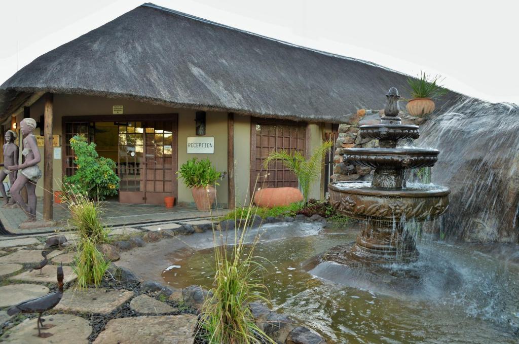 a water fountain in front of a building at Thebe River Safaris in Kasane